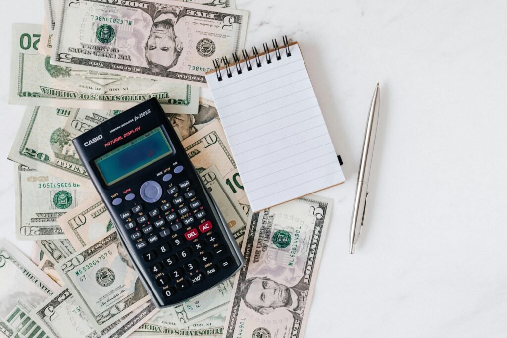 zipwp-image-4386373 Layout of bills and calculator to depict construction cash flow accounting.